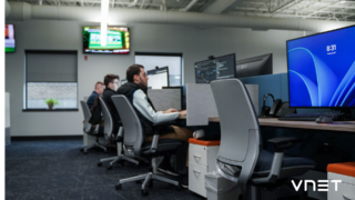 VNET employees at work on computers 